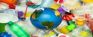 A variety of plastic items lie behind a globe